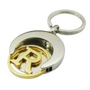 A cut out gold token is in a Football Coin Keychain.